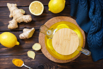 Healthy turmeric hot drink tea with lemon, ginger and honey on rustic table. Alternative medicine concept, immune system booster in winter. View from above.