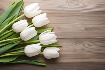 White tulips on wood table.