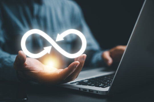 Businessman presents circular infinity symbol, signifying circular economy and infinite potential. Strategy of sustainable investment, banking, and financial growth. technology infinity data