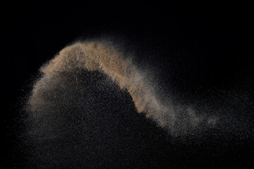 Sandy explosion isolated on black background. Abstract particles cloud. Texture element for design.
