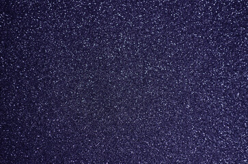 Fondo de brillos / textura glitter de color violeta/morado oscuro. Se puede usar como fondo de celebración, fiesta, año nuevo, navidad.