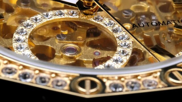 gear drive motion in skeleton watch. Mechanical watches with gears and cogs. clock mechanism. Clockwork details and parts. Inside watch, mechanical watch in macro view. expensive watch with diamonds