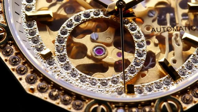 gear drive motion in skeleton watch. Mechanical watches with gears and cogs. clock mechanism. Clockwork details and parts. Inside watch, mechanical watch in macro view. expensive watch with diamonds