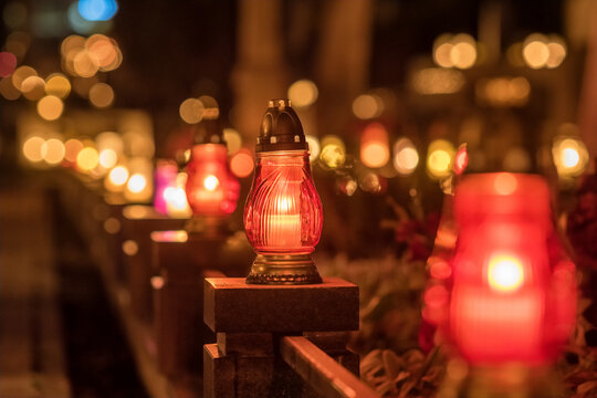 Candle lights at the cemetery at night in Poland during All Saints Day