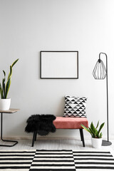 Pink bench with cushion, fur rug, lamp and houseplant near white wall