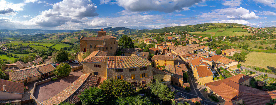 Val d'Oingt, France - 08 29 2021: Rh&ocirc;ne Vineyard. View of the Saint-Mathieu de Oingt Church and the village with the vine field and countryside around.