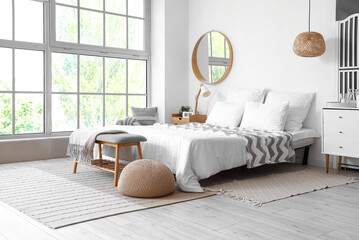 Interior of light bedroom with soft bench