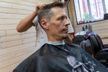  professional hairdresser cuts a man's hair. visit to the barber shop