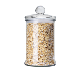 Oats in glass jar isolated on white background. Dry, uncooked oatmeal flakes