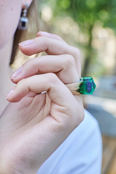 Wooden ring made of epoxy resin on a girl's hand. Women's jewelry made from natural materials.