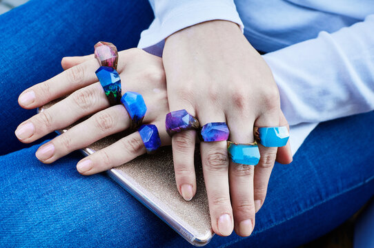 Wooden ring made of epoxy resin on a girl's hand. Women's jewelry made from natural materials.