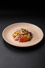 Delicious fresh juicy salad of sliced chicken, grapefruit, lettuce, sesame with olive oil