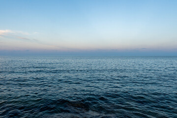 The blue mediterranean sea and a colorful horizon at Cala Ratjada on Majorca Island, Spain