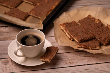 photo on the kitchen table, a delectable slice of royal cheesecake, homemade with cottage cheese, awaits. it beckons as the perfect dessert for a coffee break, complementing cup of coffee.