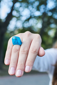 Wooden ring made of epoxy resin on a girl's hand. Women's jewelry made from natural materials.