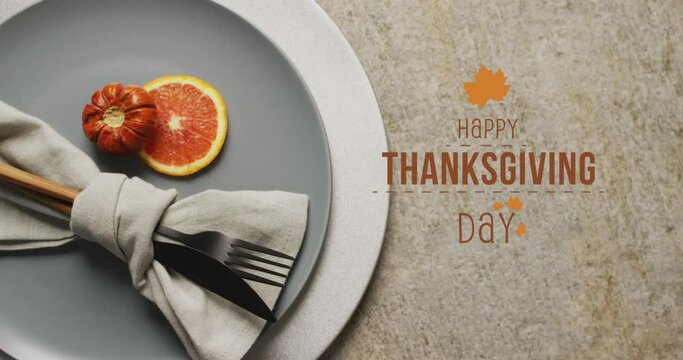 Animation of happy thanksgiving day text over place setting