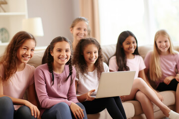 A diverse group of happy children, representing various nationalities, gathered in front of a laptop. Group education, children's circle