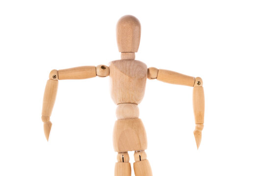 A wooden mannequin standing on a white surface. This versatile image can be used for various concepts and themes.