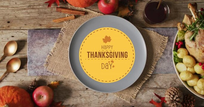 Animation of happy thanksgiving text and place setting over wooden background