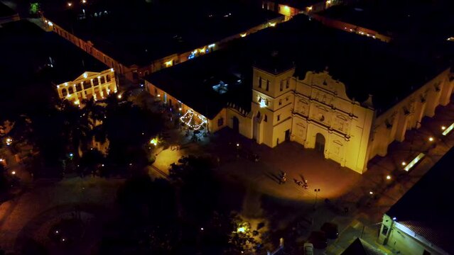 Aerial approaching over the facade of the Cathedral of Comayagua during a dark night
