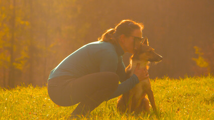 CLOSE UP: Loving moment between a young lady and her adorable shepherd dog