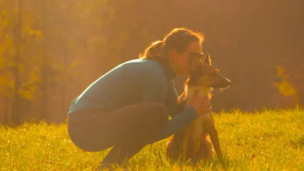 Poster CLOSE UP: Loving moment between a young lady and her adorable shepherd dog © helivideo
