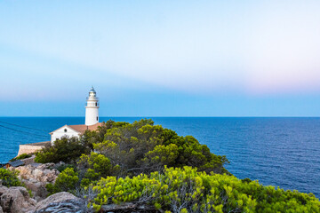 Capdepera Lighthouse at the beautiful coast with the Mediterranean Sea and stunning cliffs of Cala Ratjada on Majorca Island, Spain