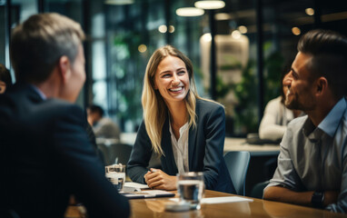 Fototapeta premium Group of people discussing and smiling at work in an office