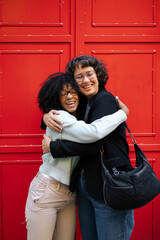 Two friends hugging in the street