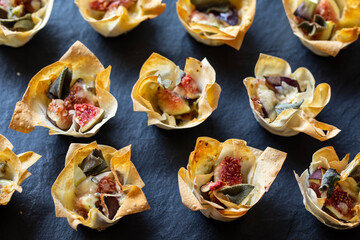 Christmas canapes, filo pastry cups with figs and blue cheese