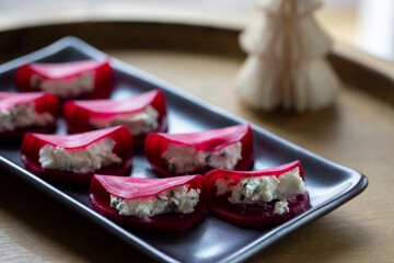 Christmas canapes with pickled beetroot and goat cheese