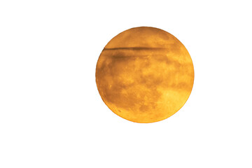 Super moon in orange color. Full moon in orange tones. some clouds are in front of the moon