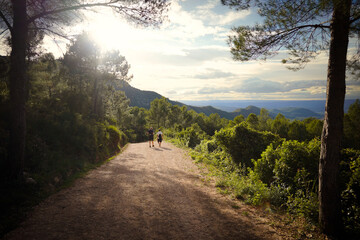 two people walking on the mountain