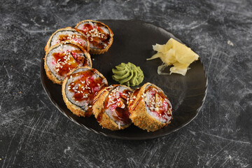 sushi with salmon, avocado, cream cheese, cucumber, rice, tuna in a plate