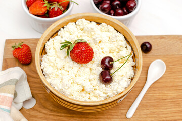 Cottage cheese with summer strawberries cherry.curd cheese in bowl.Healthy dairy Calcium,Protein product,food breakfast,lunch,lifestyle,dieting, detox,proper nutrition.Top view