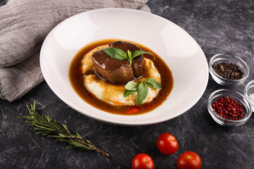 Potato with meat, sauce and vegetables