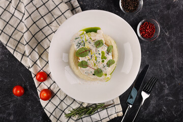 A portion of Russian beef patties with mashed potatoes and herbs