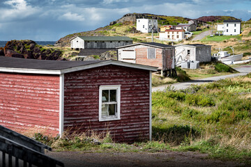 Rustic East Coast buildings along a hillside overlooking the Atlantic Ocean in Keels Newfoundland and Labrador Canada.