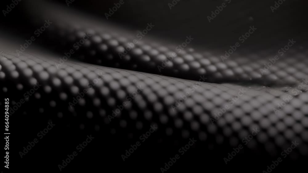 Poster closeup of a matte finish rubber texture with a small, uniform dot pattern. the texture has a matte,