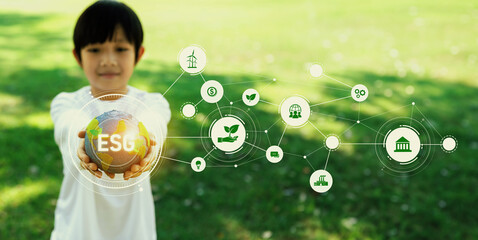 Focused planet Earth globe with eco friendly icon hold by blur little boy, symbolize environmental...