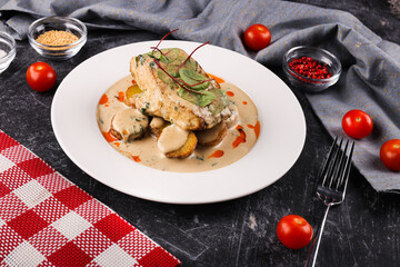 Delicious fillet of pollock or coal fish, cooked in a spicy marinade and served with potatoes