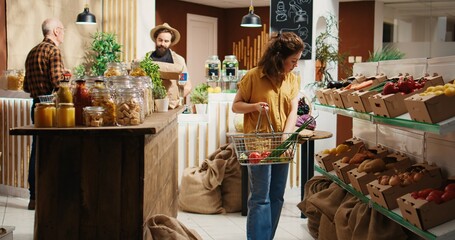 Bustling zero waste supermarket full of customers roaming around aisles looking for organic pantry...