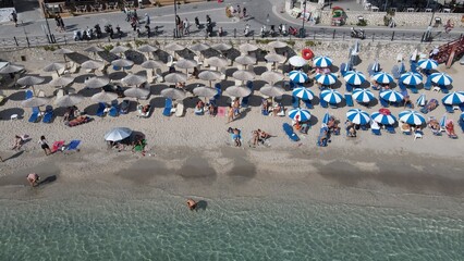 Aerial drone view parga greece, beach crowded with tourists in vacation on summer in famous greek caribbean parga town epirus preveza