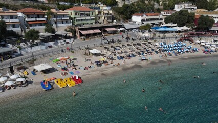 Aerial drone view parga greece, beach crowded with tourists in vacation on summer in famous greek caribbean parga town epirus preveza