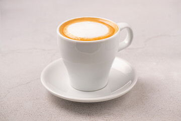 Latte cup isolated on gray background. White cup. Brazilian coffee.