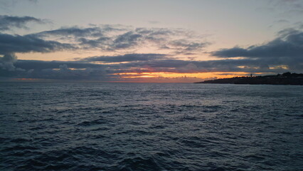 Amazing golden skyline ocean water rippling. Aerial sunset light shining horizon