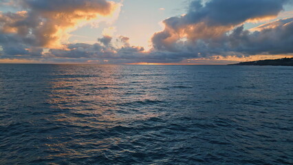 Cloudy evening sky ocean water rippling in slow motion. Endless sea at sunset.