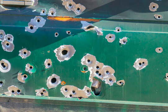 bullet holes, texture, metal, shooting, shooting on the street, shot, target, bullet, grapeshot, gunpowder, background. bullet holes in the metal. multiple bullet marks on the car body. peeling green