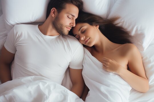 Top view of romantic scene of a couple sleeping in bed in the morning