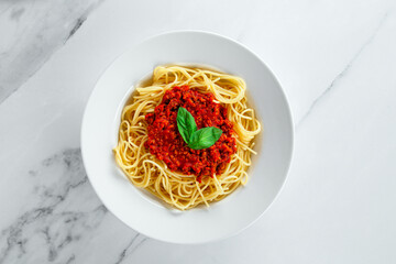 Horizontal Italian Spaghetti Pasta Noodle Dinner on Bright White Marble Kitchen Table.